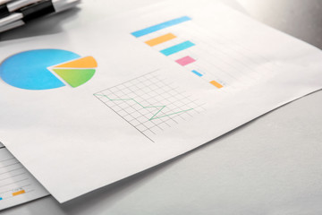 Document with graph and diagrams on table