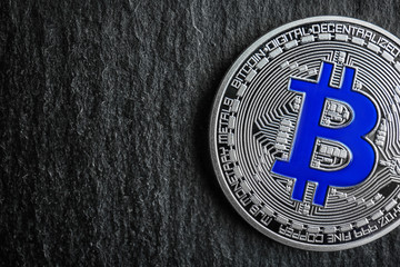 Silver bitcoin on dark background, closeup