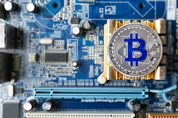 Silver bitcoin on PC motherboard