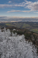 Fototapeta na wymiar View from Semnicka rock with cloudy sun and snow in west Bohemia