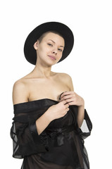 Beautiful young girl in black tunic and black hat.