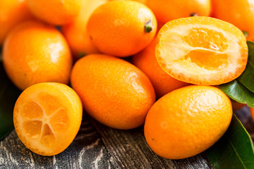 Kumquat or cumquat on wooden table