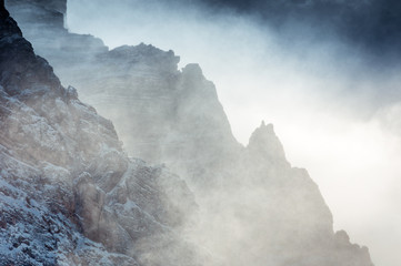 Winter view of Mount Pelmo crests with fog and clouds, Dolomites, Italy