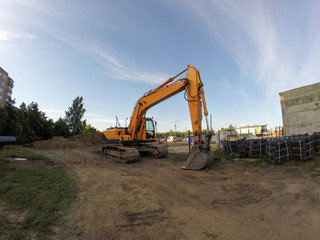 Fototapeta na wymiar Yellow excavator in the construction site
