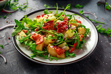 Fresh crispy Bacon, Potato salad with green vegetable on plate