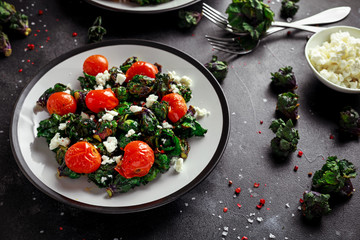 Homemade Roasted Green Kalettes salad with cherry tomatoes and feta cheese. healthy food