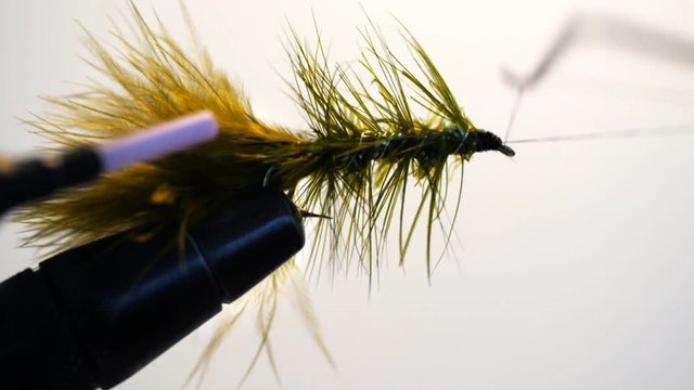whip finishing a green woolly bugger wet fly