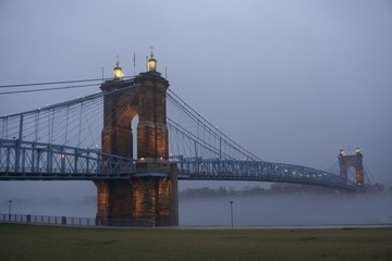 Fototapeta na wymiar cincinnati, ohio and covington kentucky riverfront and bridges in the fog on misty day at dusk