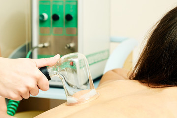 Obraz na płótnie Canvas Medical procedure. Vacuum massage. Girl patient