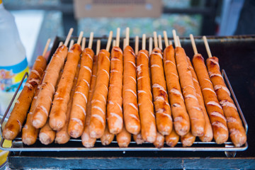 Grilled sausage on wooden skewer