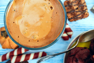 cappuccino muffins and wafer tubules on a dark wooden background 