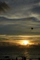 Sunset at sea. Parachute. Free flight