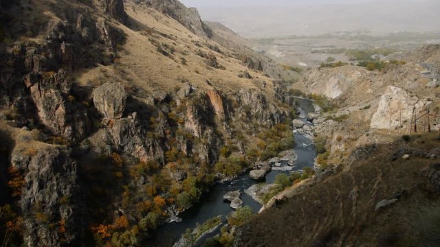Mountain river flows between huge rocks