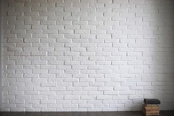 Asian young novice on a white brick wall