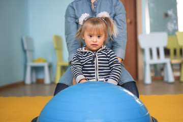 mom and Toddler Down syndrome Balancing Ball Yoga