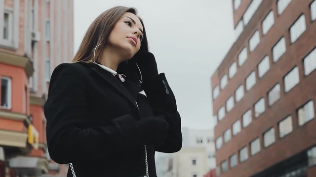 Woman listening a music in frost winter city