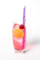 Red Cosmopolitan cocktail with vodka, rum, triple sec, red cranberry and lemon juice, pineapple, maraschino cherry in martini glass isolated on a white background