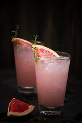 Homemade grapefruit lemonade with ice in glass
