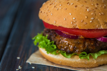 Fast food, homemade burger on a wooden background