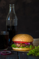 Homemade burger and Coca-Cola bottle, fast food