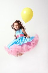 Obraz na płótnie Canvas Birthday. Little girl. Yellow balloon. Blue dress