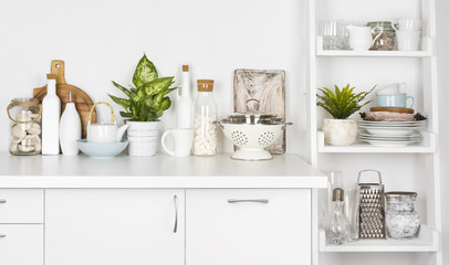 Obraz na płótnie Canvas Kitchen bench and shelf with various utensils on white background