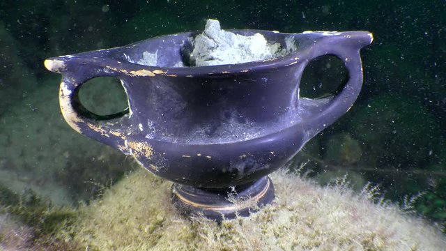 Underwater archeology: Ancient Greek Black-glazed ware on the seabed, kantharos, close-up.

