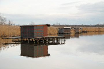 bizzare post-apo looking cottages with narrow catwalks on Hermanicky pond, Czech Republic