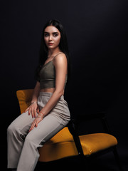 Naklejka premium Model brunette posing isolated at black