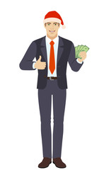 Businessman in Santa with cash money and showing thumb up