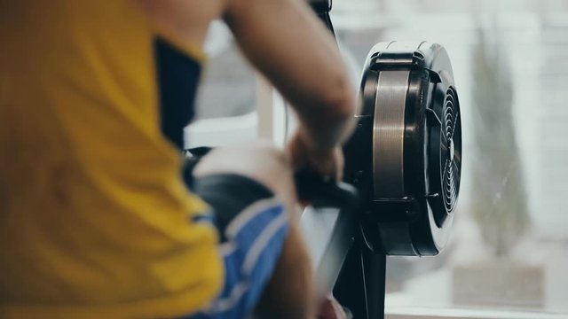 Someone man make rowing boating exercise in gym