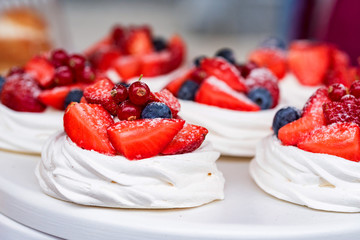 Meringue pastries with berries and fruits