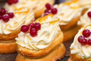 Delicious pastries with berries and butter cream