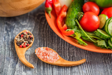 Fresh rustic vegetable salad on rustic background