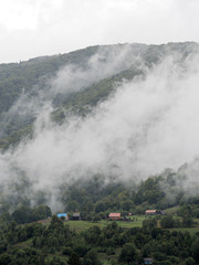 Fog and mist at the village in carpatian mountains