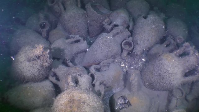 The crash site of the ancient ship: the camera moves over the cluster of ancient Greek amphorae on the seabed.
