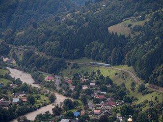 Fototapeta premium Carpatian mountains village at green forest