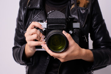 Fototapeta premium Retro camera. Girls hands. White background
