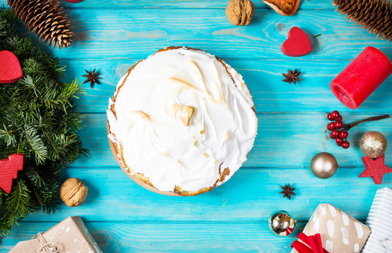 The white cream cake and christmas decor on blue wood background.