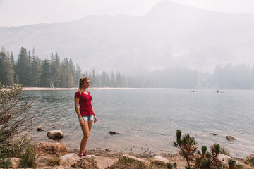 Young girl exploring Yosemite National Park near California by lakes forests and mountains 