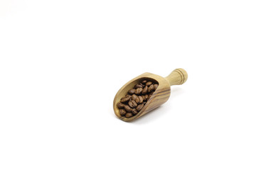 Fresh coffee beans in a wooden spoon