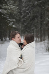 Fototapeta premium pair of lovers on a date winter afternoon in a snow blizzard