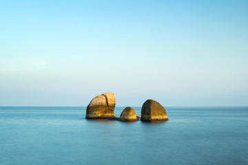 Fototapeta na wymiar three stones in smoothes water in Thailand