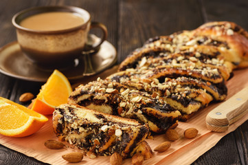 Homemade poppy seed braided bread on wooden background.