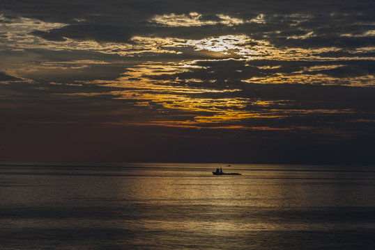 Single boat in twilight evening with clouds