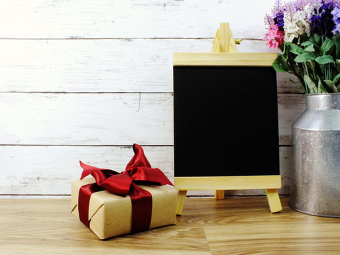 christmas new year presents box and space black board for copy on wooden table