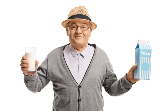 Mature Man Holding A Glass Of Milk And A Milk Carton