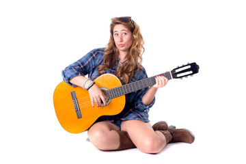beautiful young girl playing the guitar