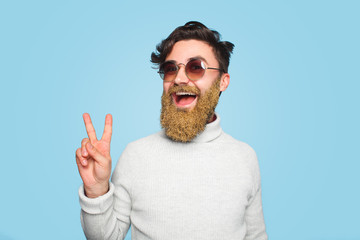 Happy young man with beard covered in glitter