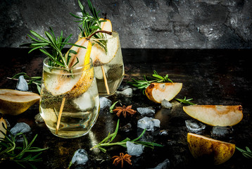 Sweet pear and rosemary cocktailAlcohol drink, Sweet pear cocktail with rum, liquor, anise and rosemary, On a black rusty metallic background, copy space